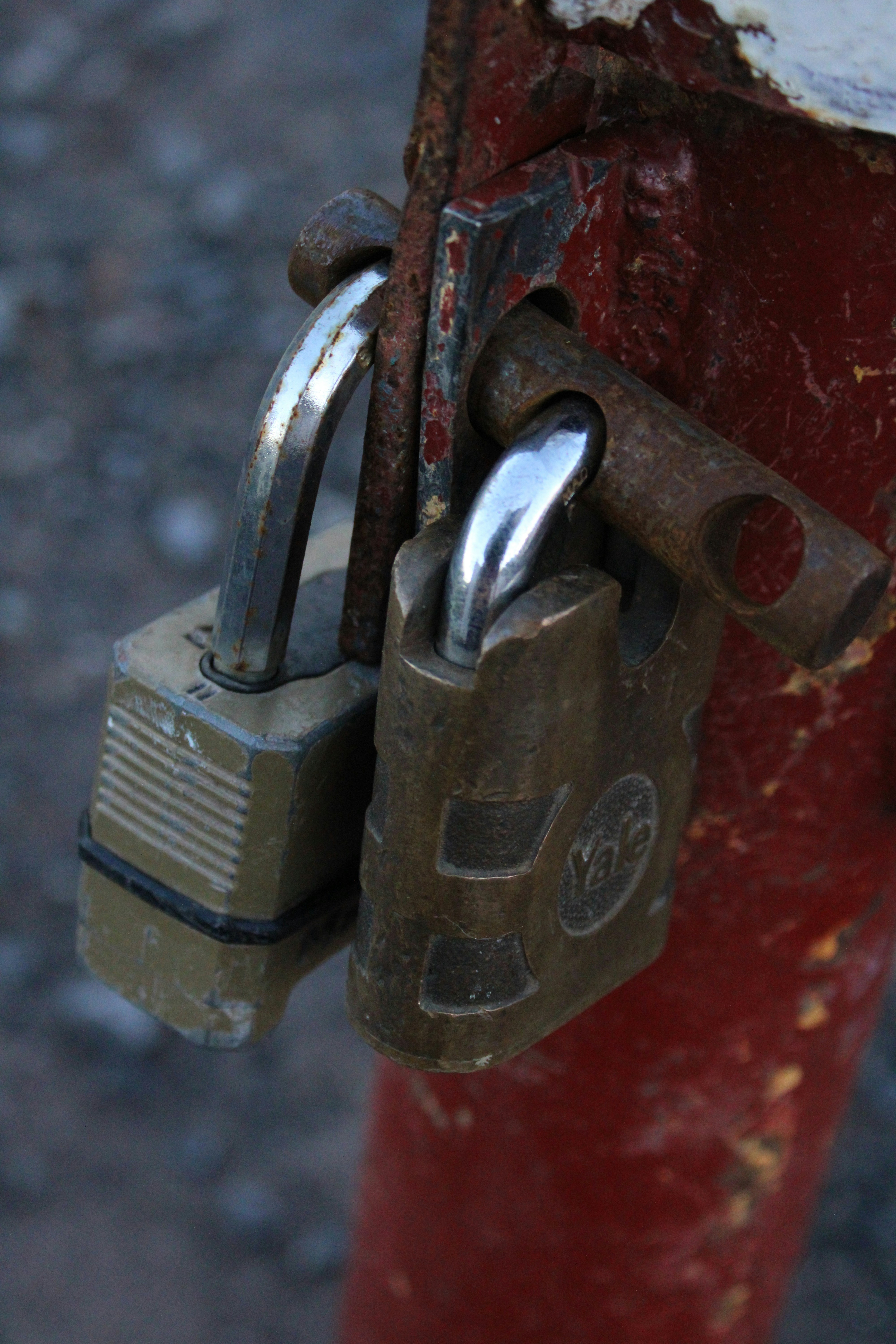 a red fire hydrant with two padlocks attached to it